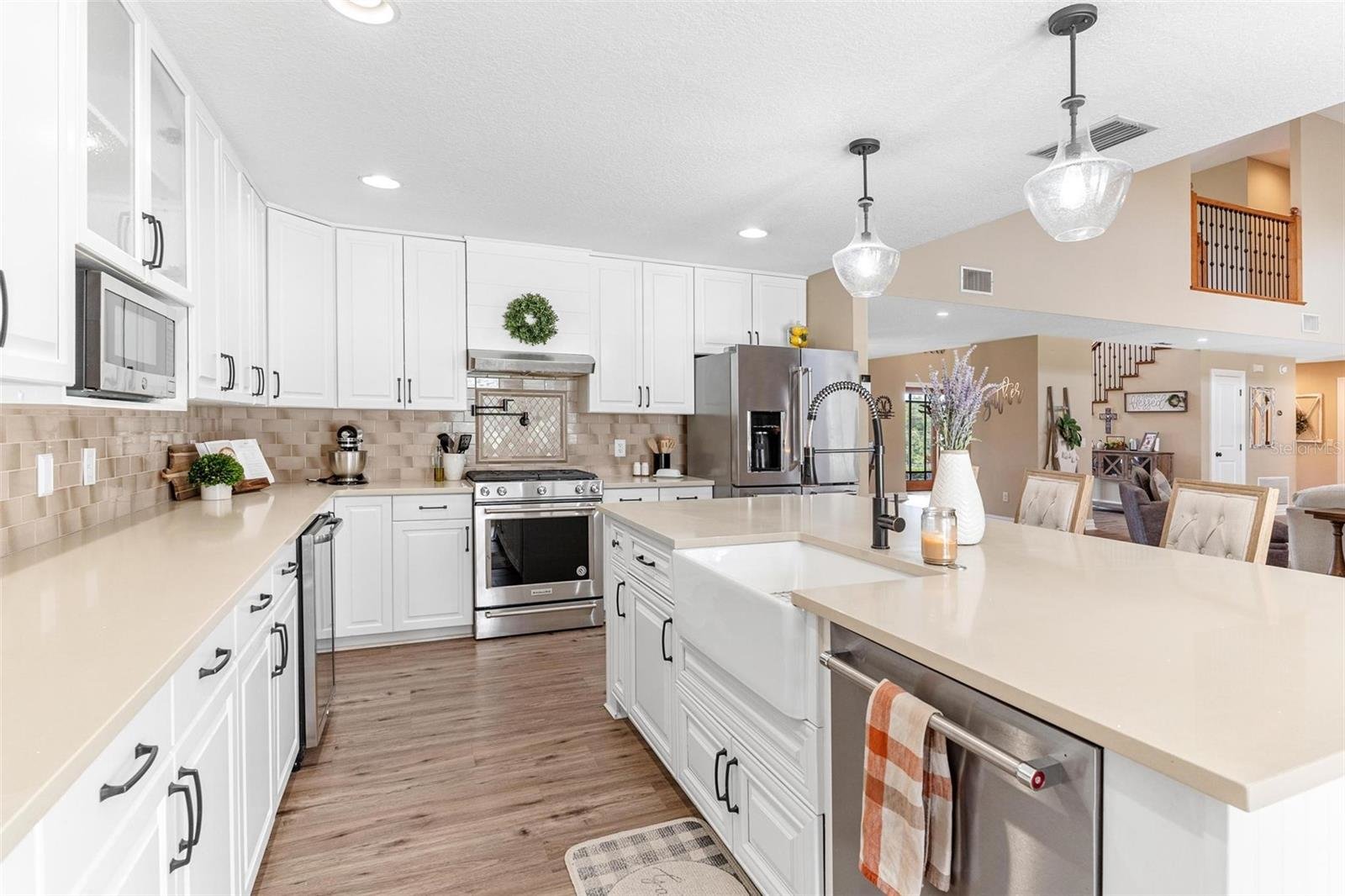 kitchen with white cabinets and large white island
